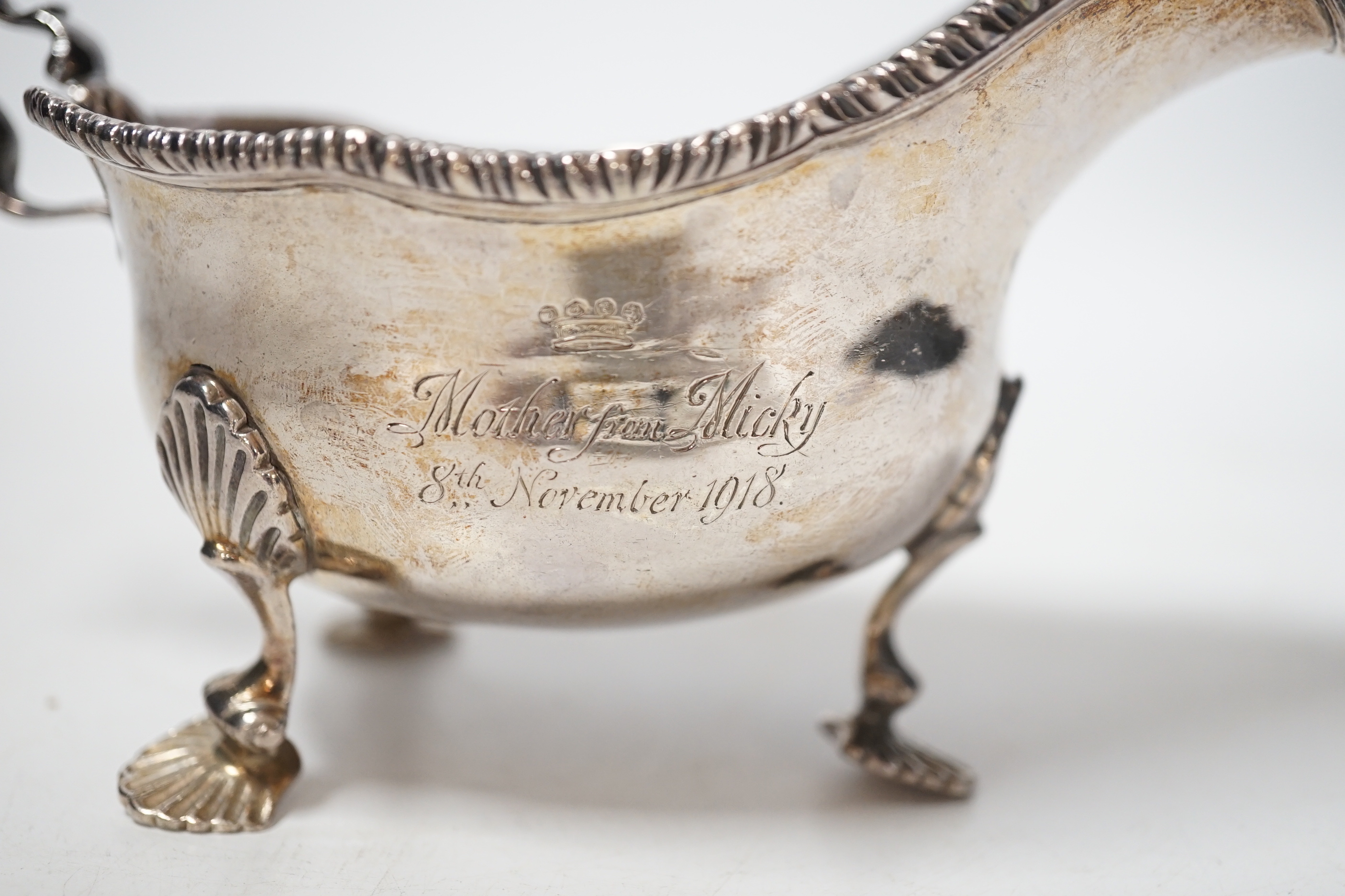 A George V silver sauceboat, on three shell feet, Thomas of New Bond Street, London, 1918, length 17cm, 8oz.